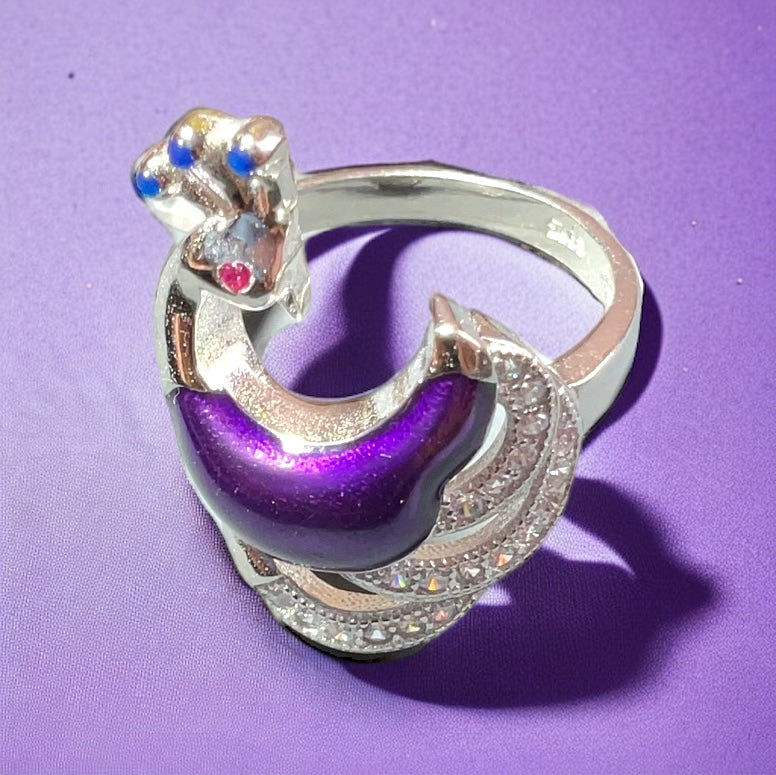 a purple and silver ring on a purple surface