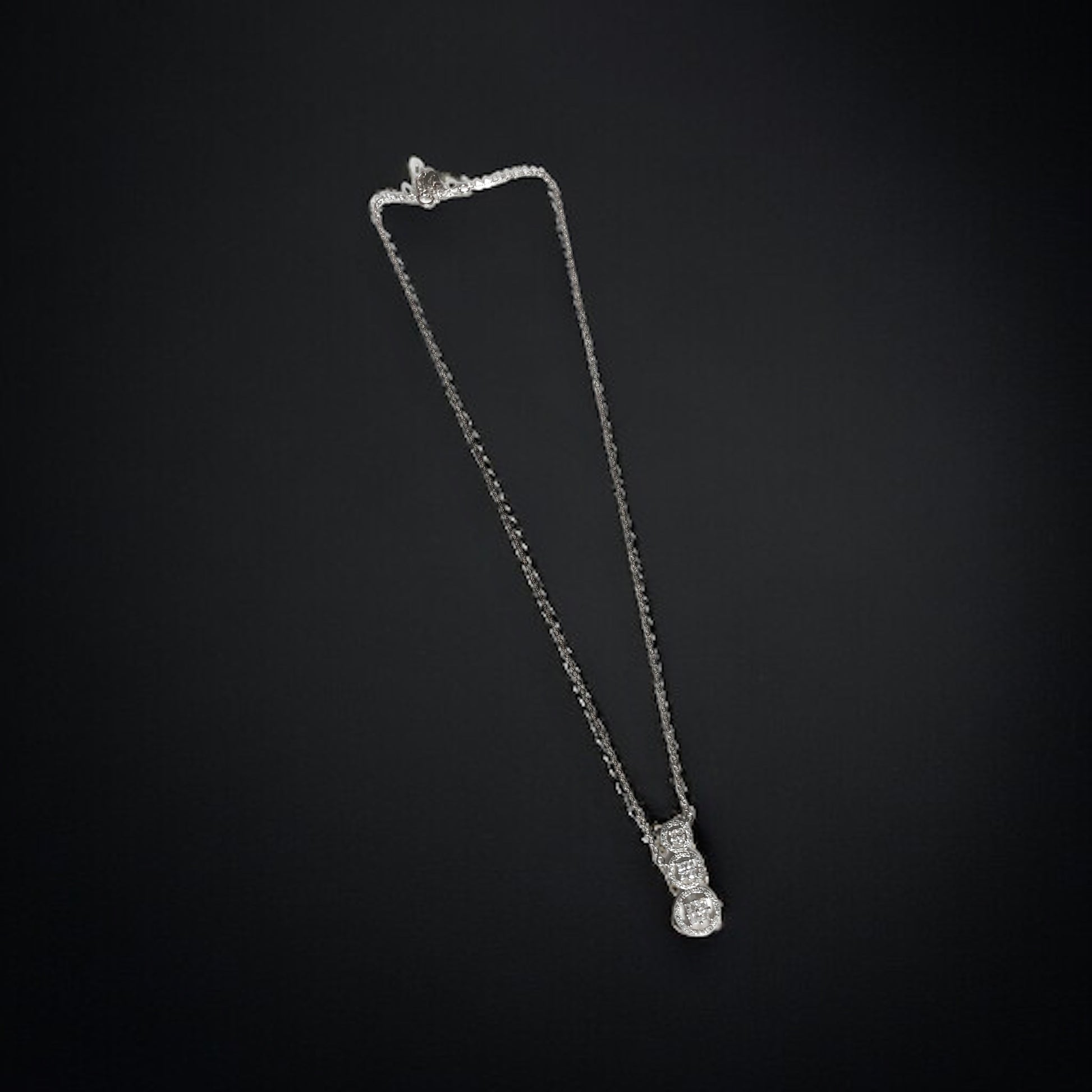 a diamond necklace on a black background