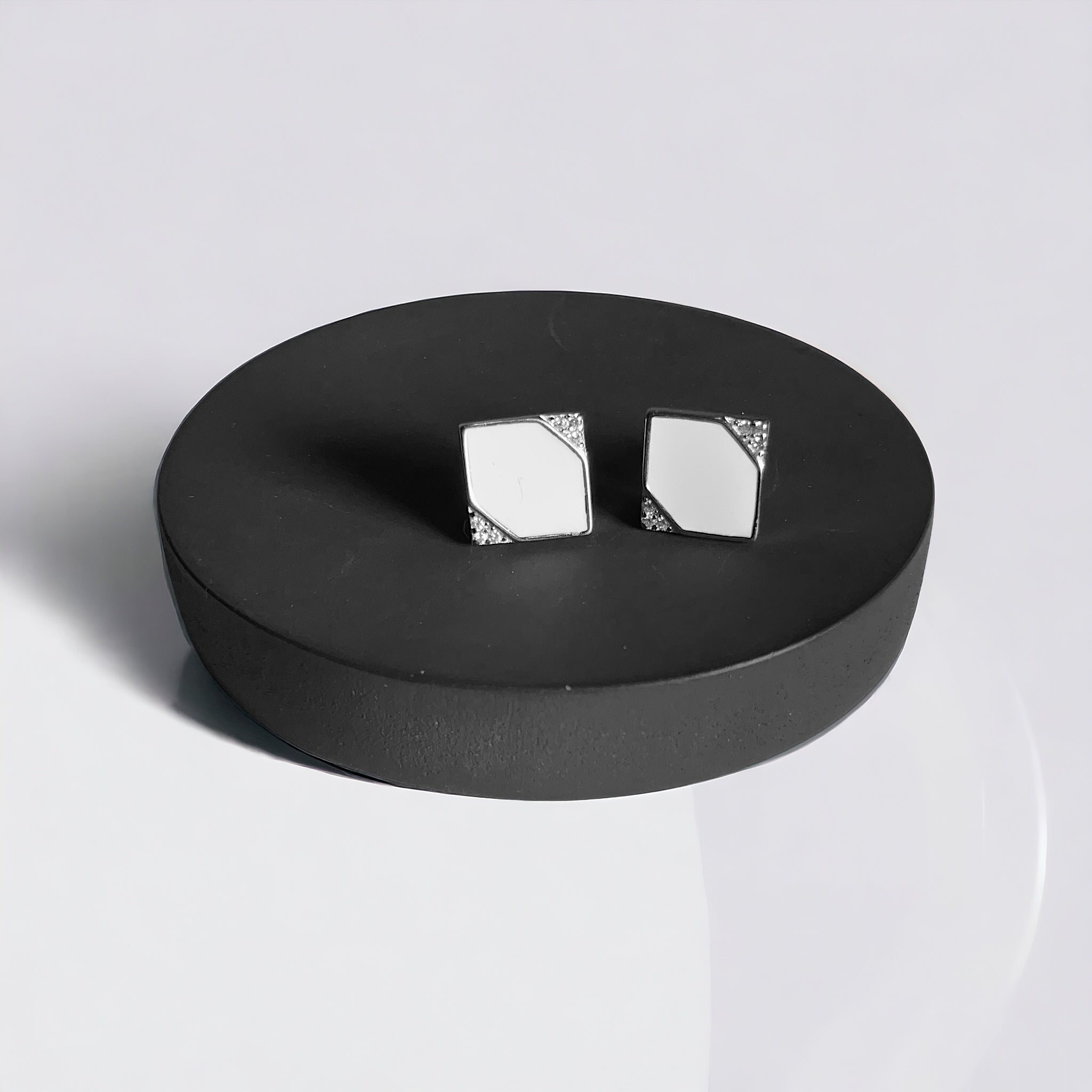 a pair of white and black square earrings