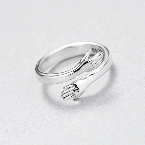 a close up of a silver ring on a white surface