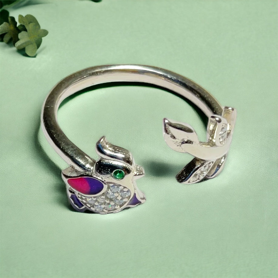 a close up of a ring with a bird on it