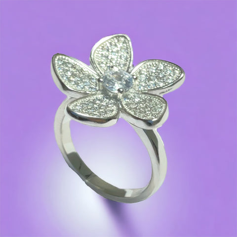 a diamond flower ring on a purple background