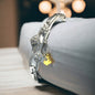 a close up of a bracelet on a bed