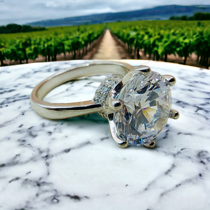 a diamond ring sitting on top of a marble table