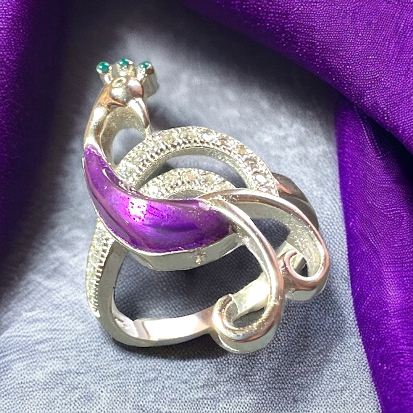a silver ring with a purple ribbon around it