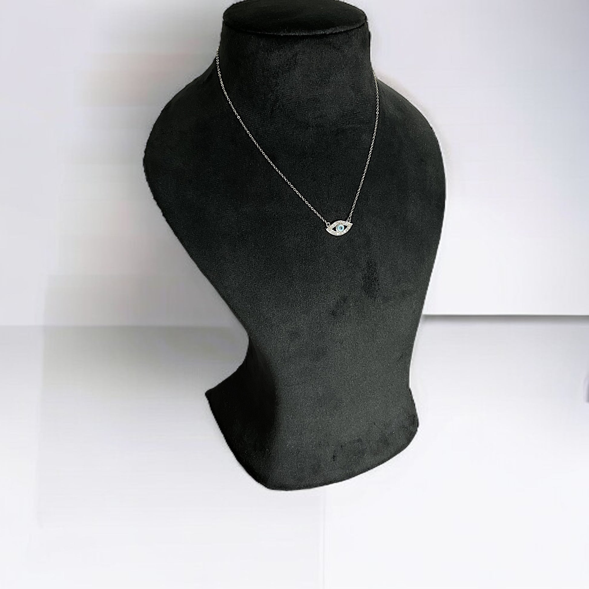 a black mannequin with a necklace on it