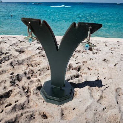 a metal object on a sandy beach near the ocean