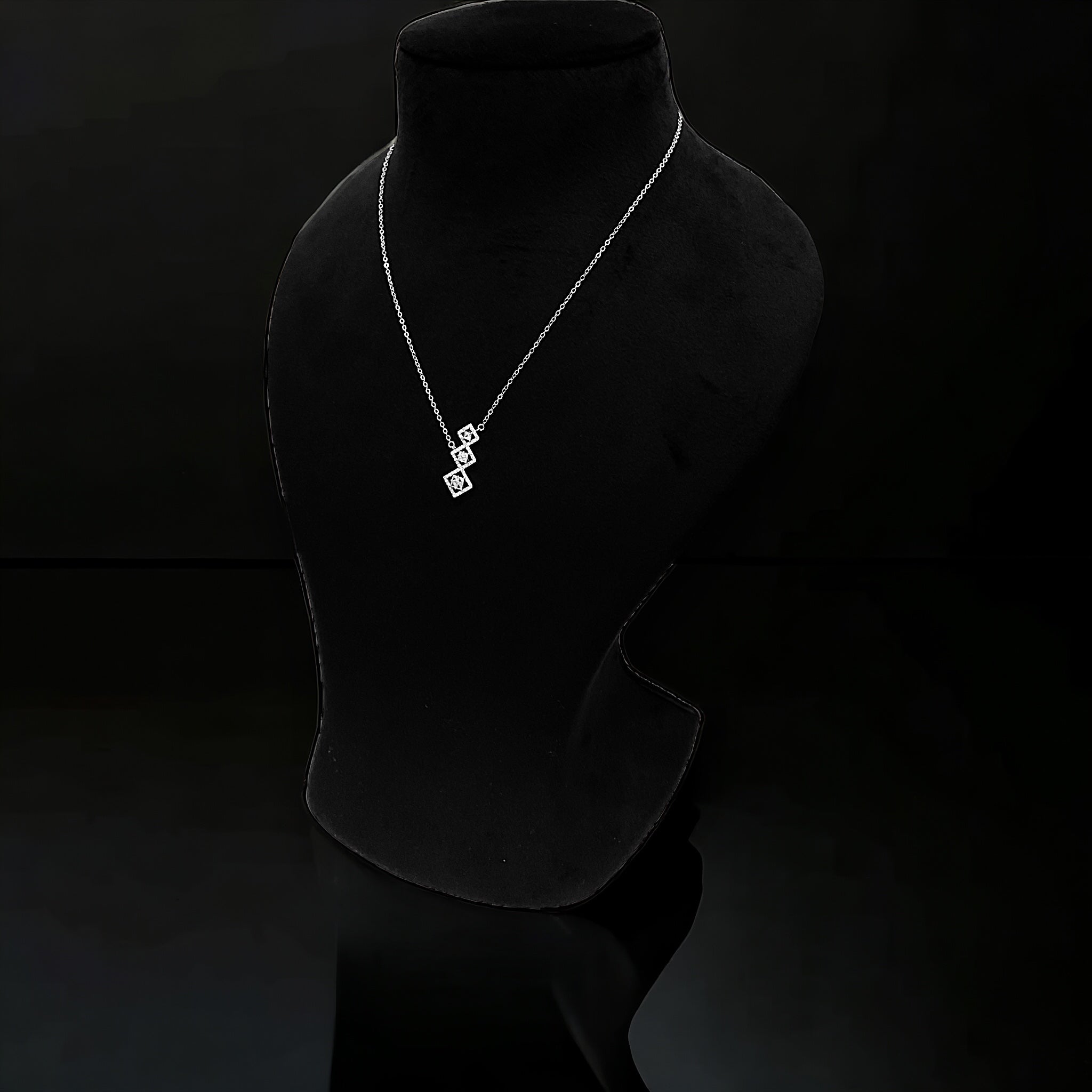a black mannequin with a necklace on it