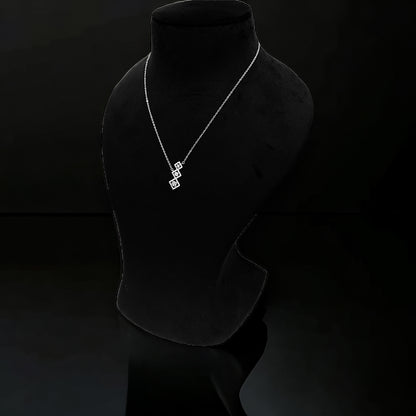 a black mannequin with a necklace on it