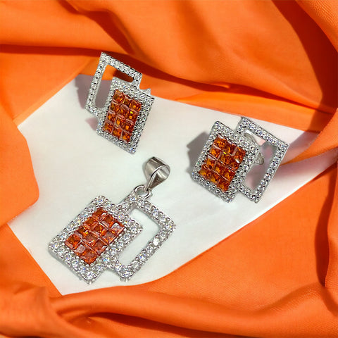 a pair of orange and white diamond earrings
