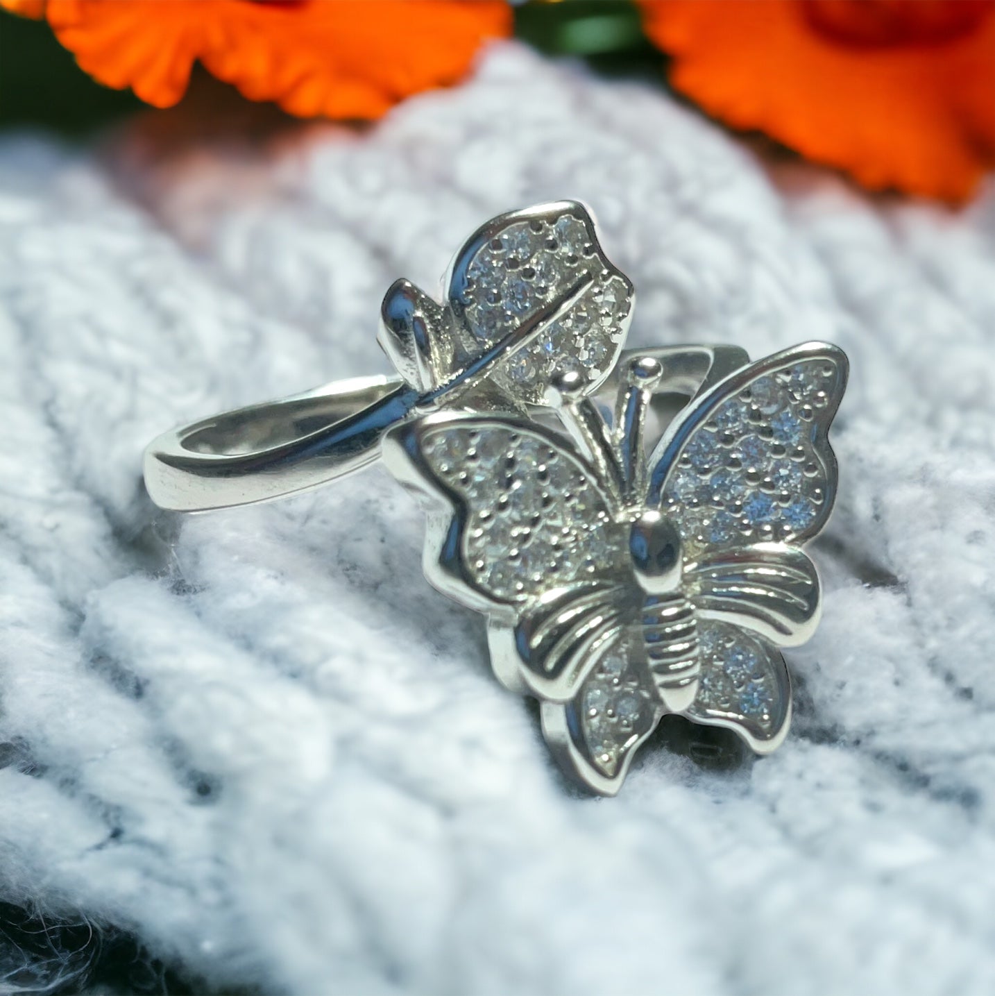 a close up of a ring with a butterfly on it