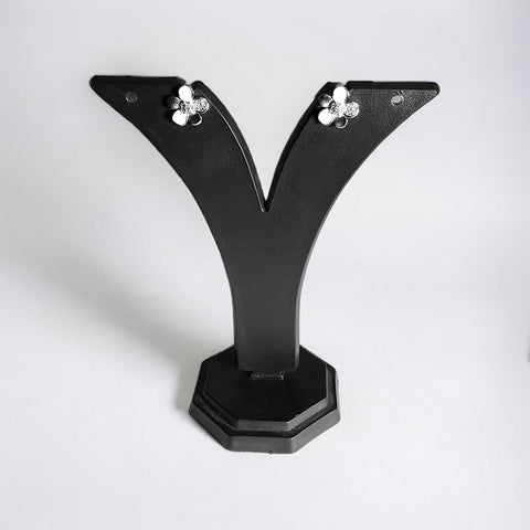 a pair of black vases sitting on top of a table