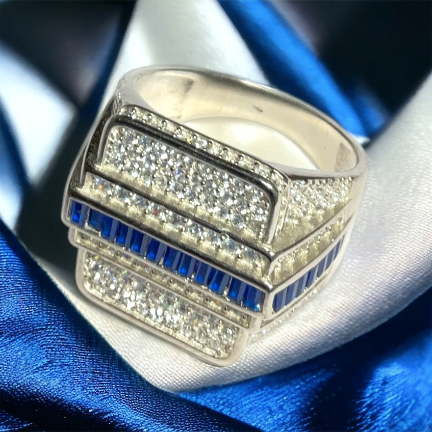 a white gold ring with blue and white diamonds