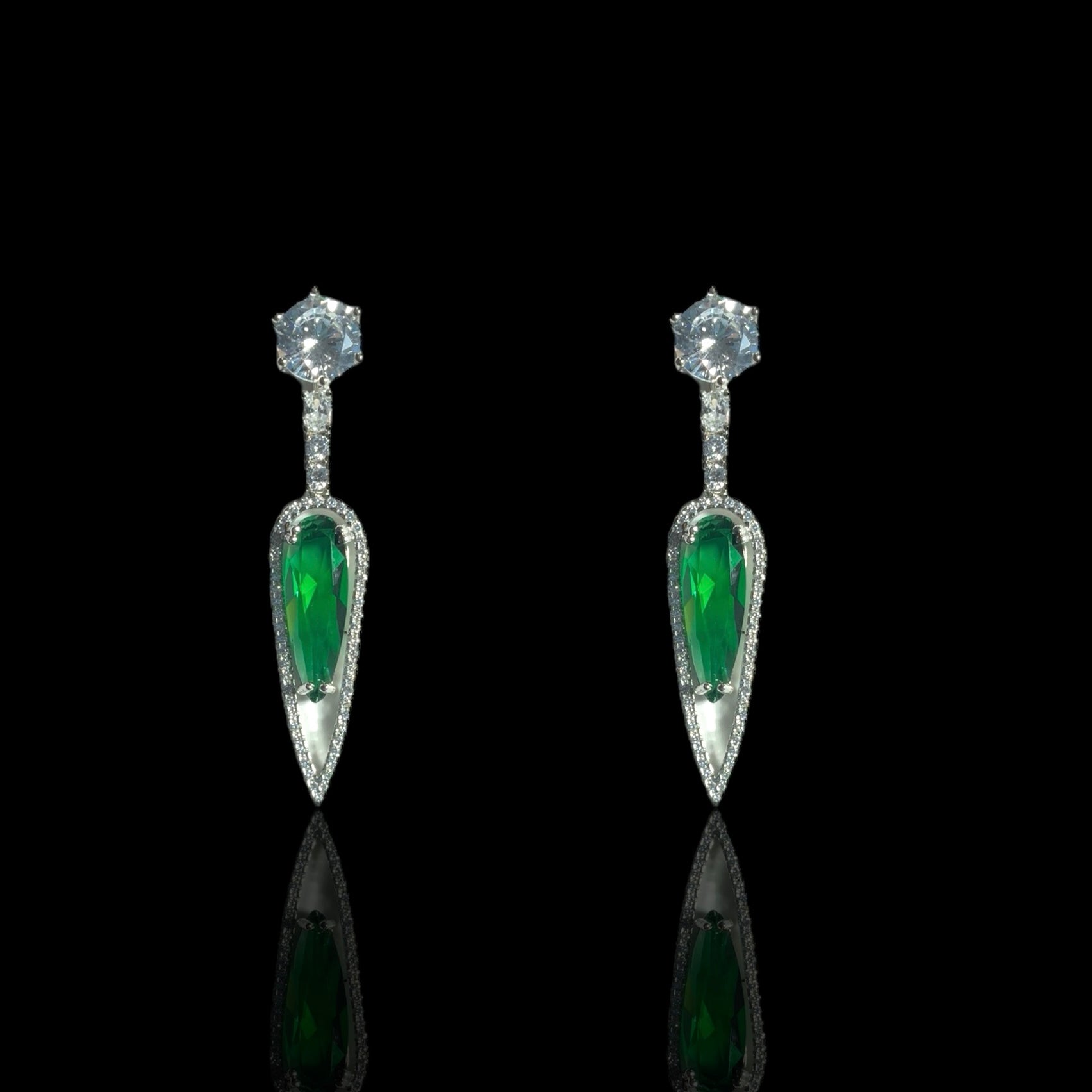 a pair of emerald and diamond earrings