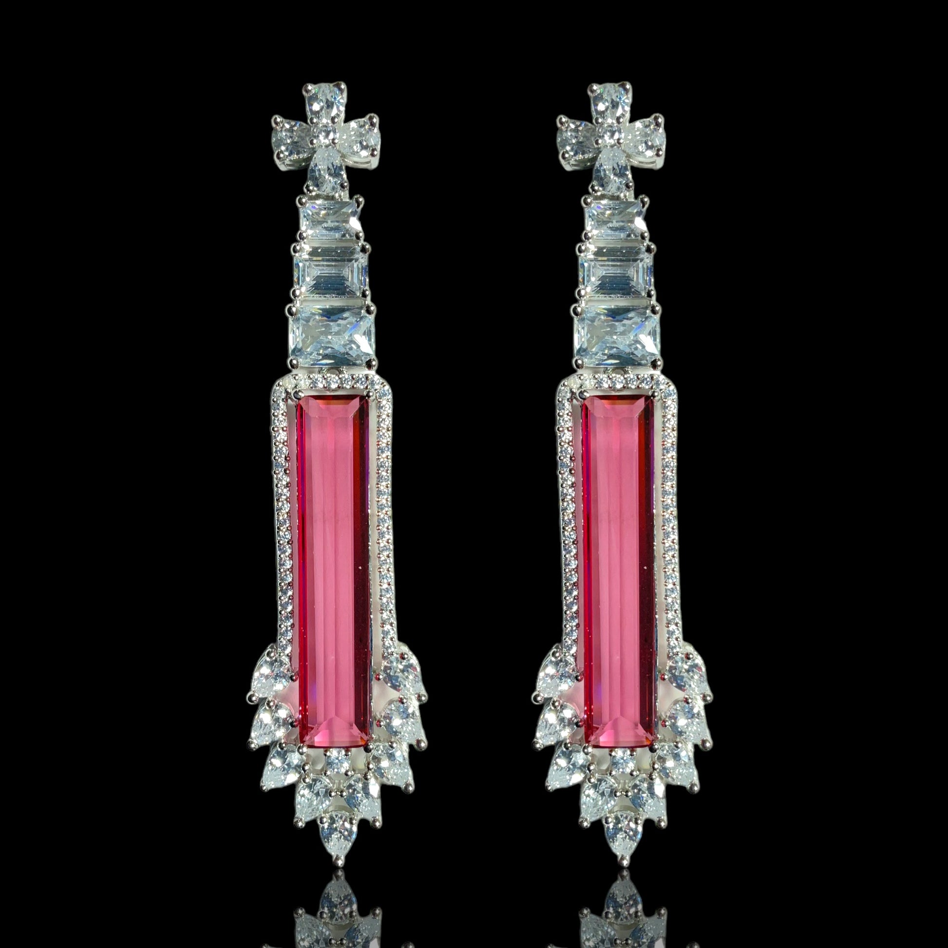 a pair of pink and white earrings