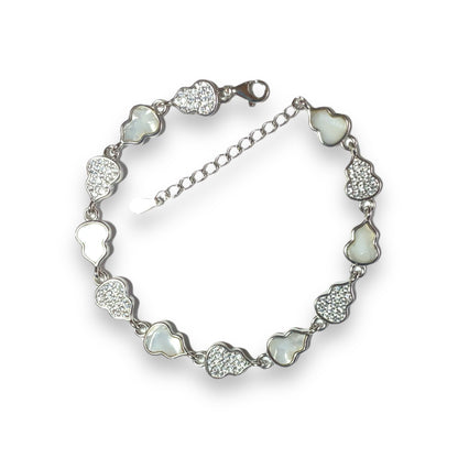 a bracelet with hearts and crystals on a white background