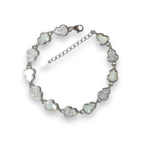 a bracelet with hearts and crystals on a white background