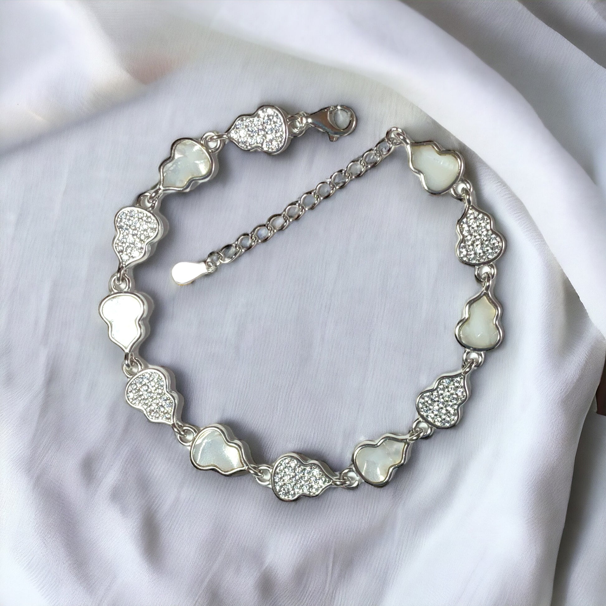 a silver bracelet with hearts on it