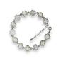 a white bracelet with flowers and crystal stones