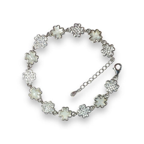 a white bracelet with flowers and crystal stones