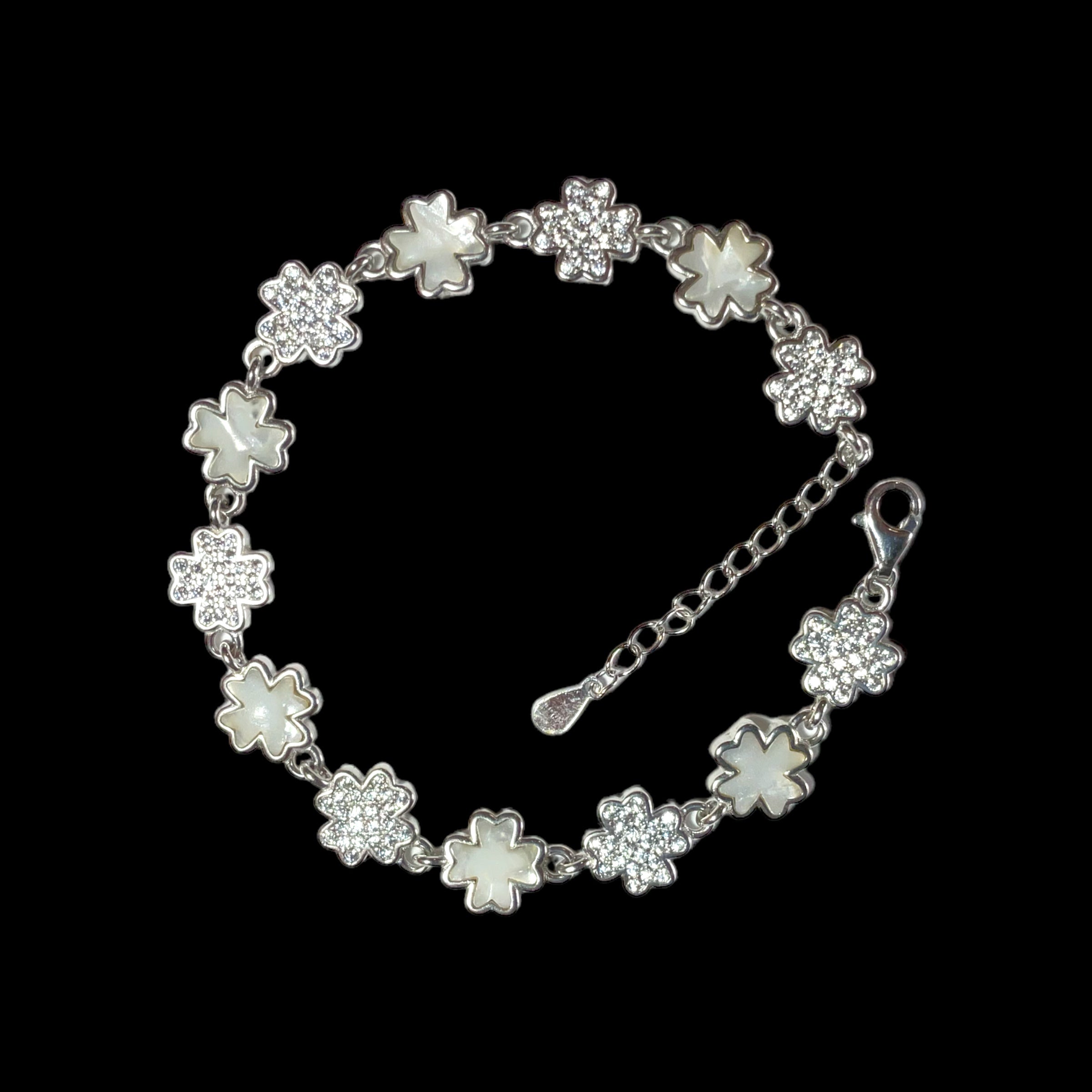 a white bracelet with flowers and a chain