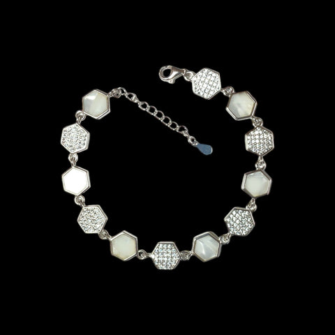 a silver bracelet with white stones and diamonds