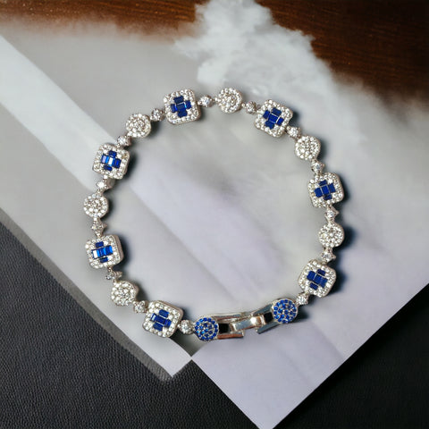 a blue and white diamond bracelet on a table