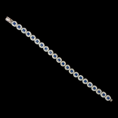 a blue and white bracelet on a black background