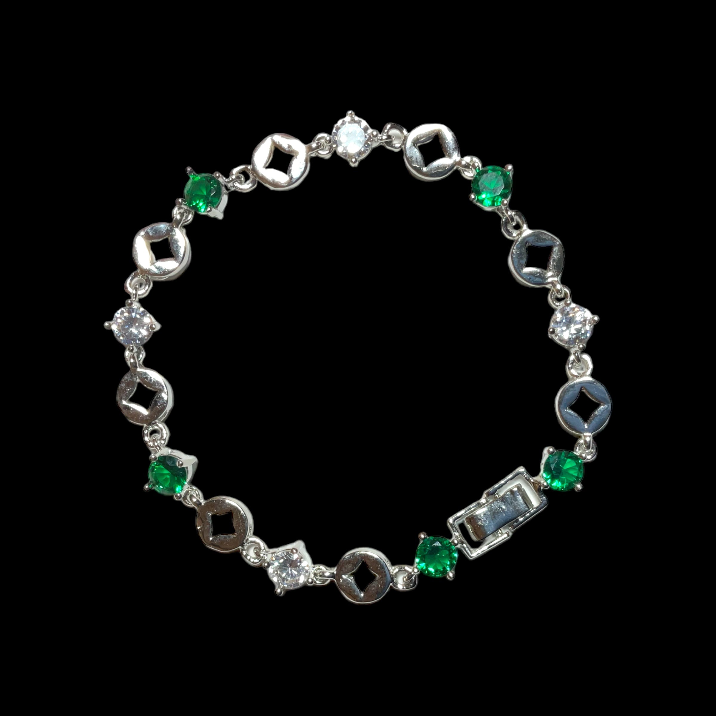 a bracelet with green and white stones on a black background