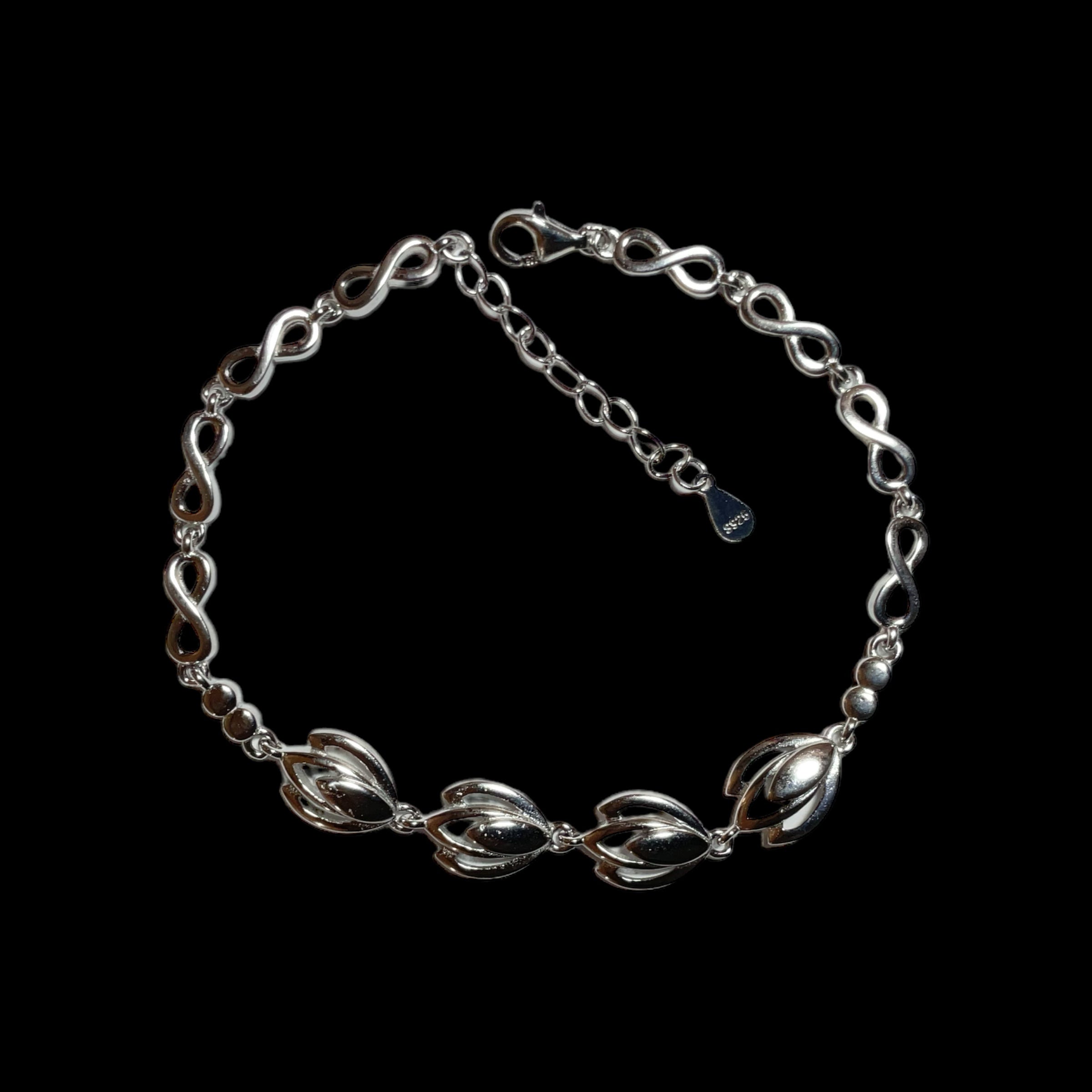 a silver chain bracelet with a clasp on a black background