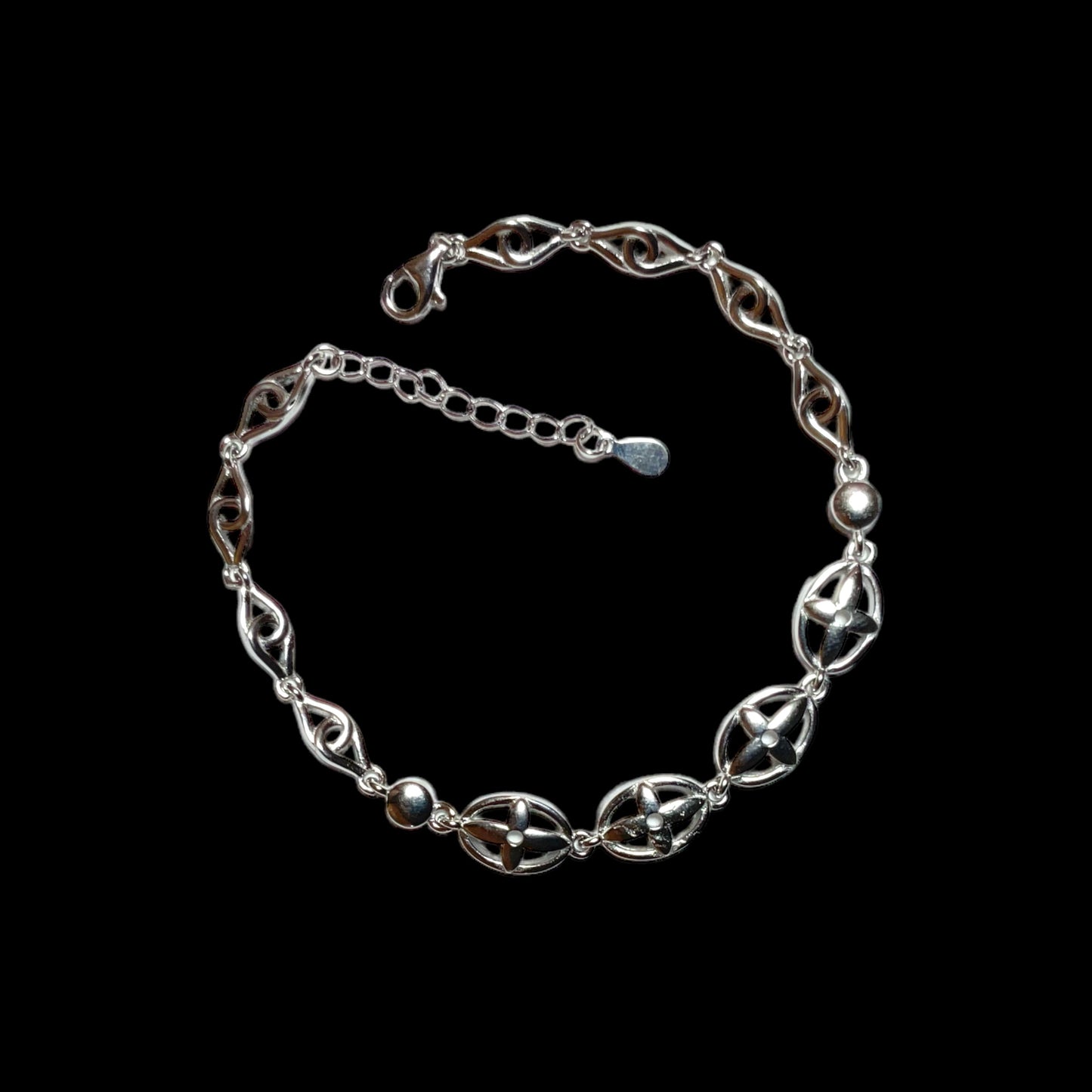 a silver chain bracelet with a clasp on a black background