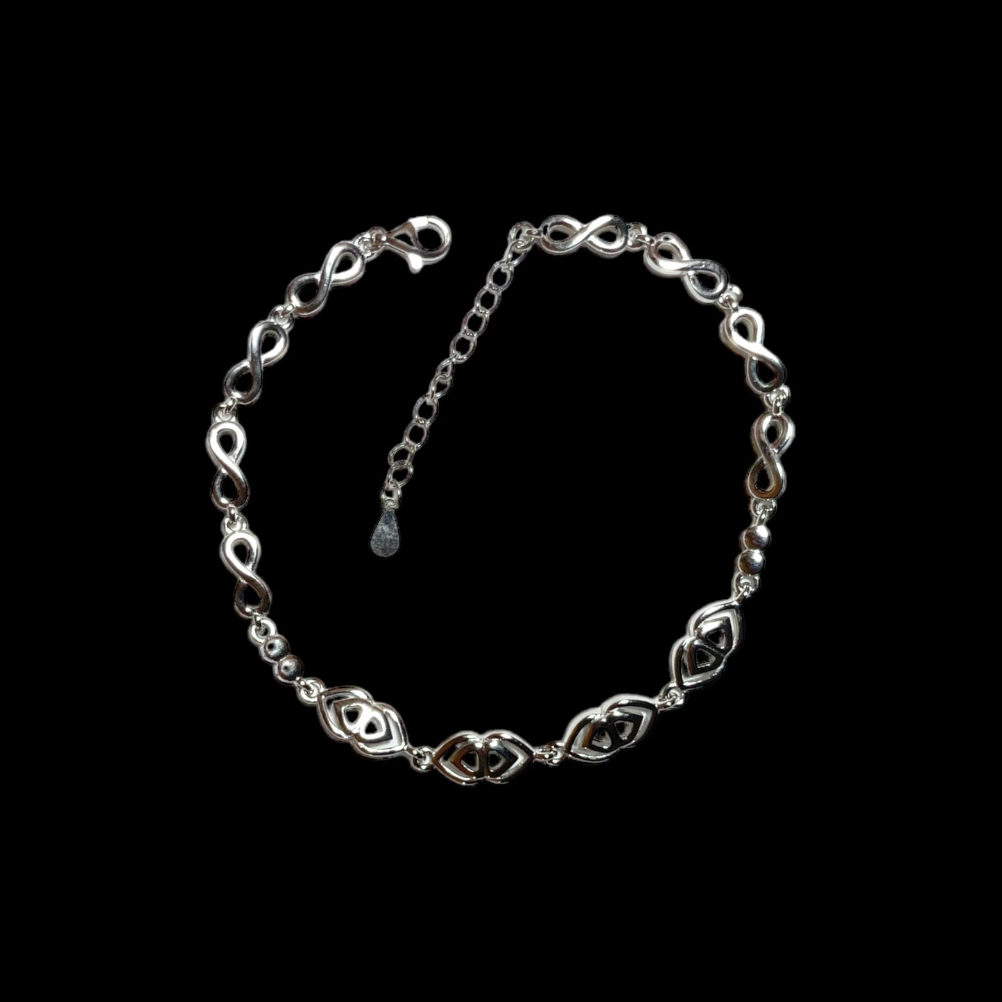 a silver chain bracelet with a heart charm