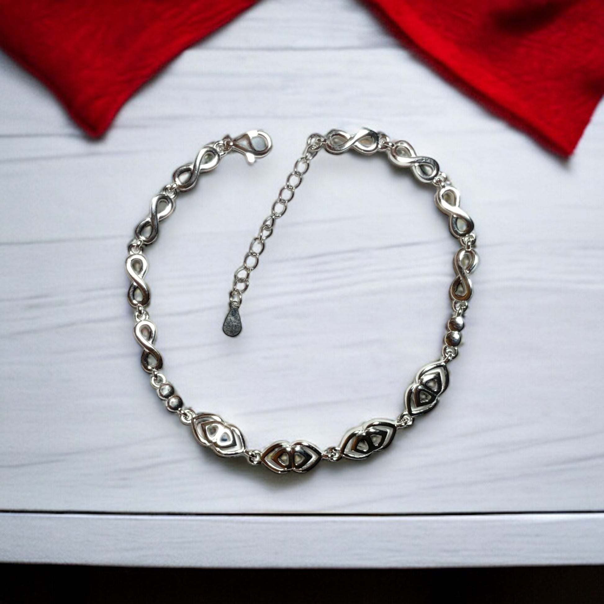 a silver bracelet with a heart on it