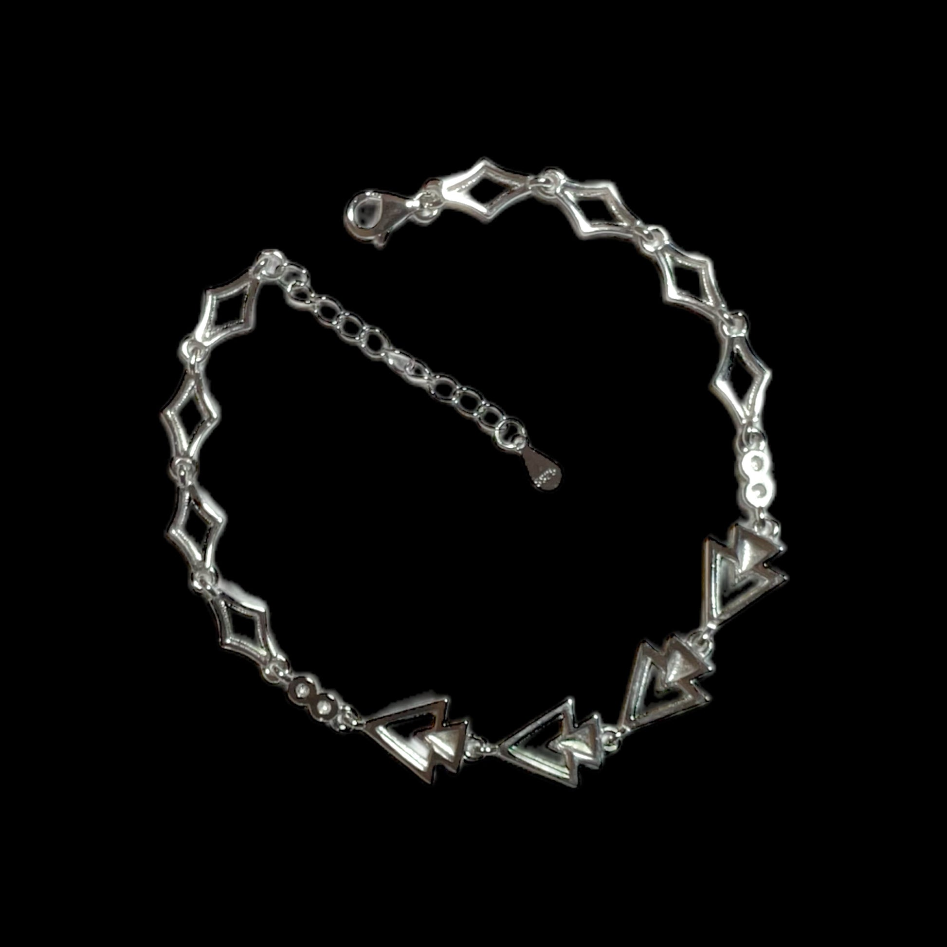 a silver bracelet with an arrow design on it