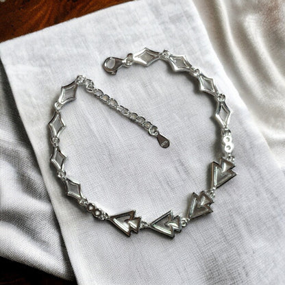 a close up of a bracelet on a table