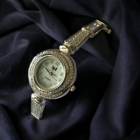 a close up of a watch on a black cloth