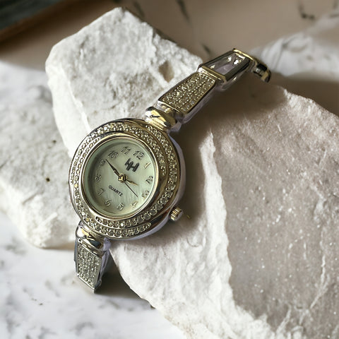 a close up of a watch on a rock