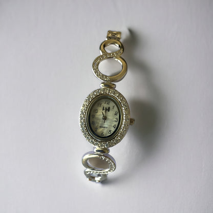 a close up of a watch on a white surface