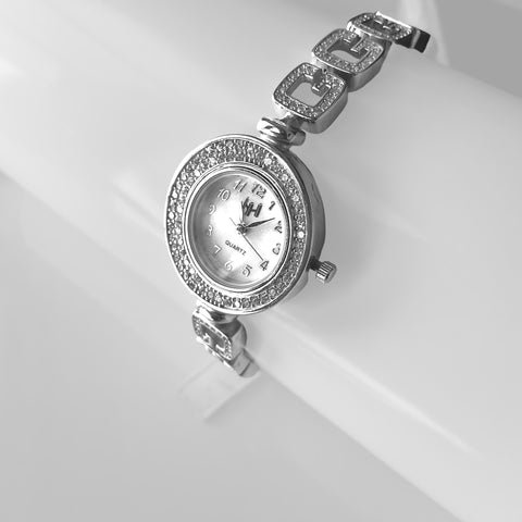 a woman's watch with a diamond bezel