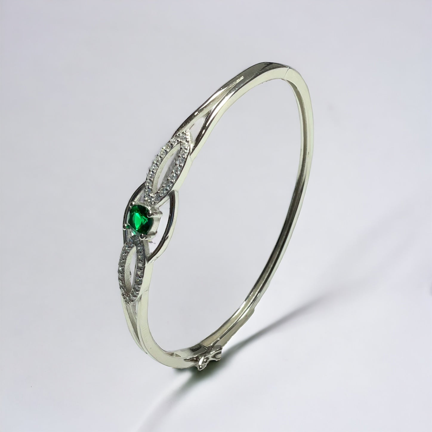 a close up of a ring with a green stone