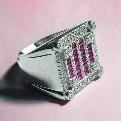 a silver ring with red and white diamonds