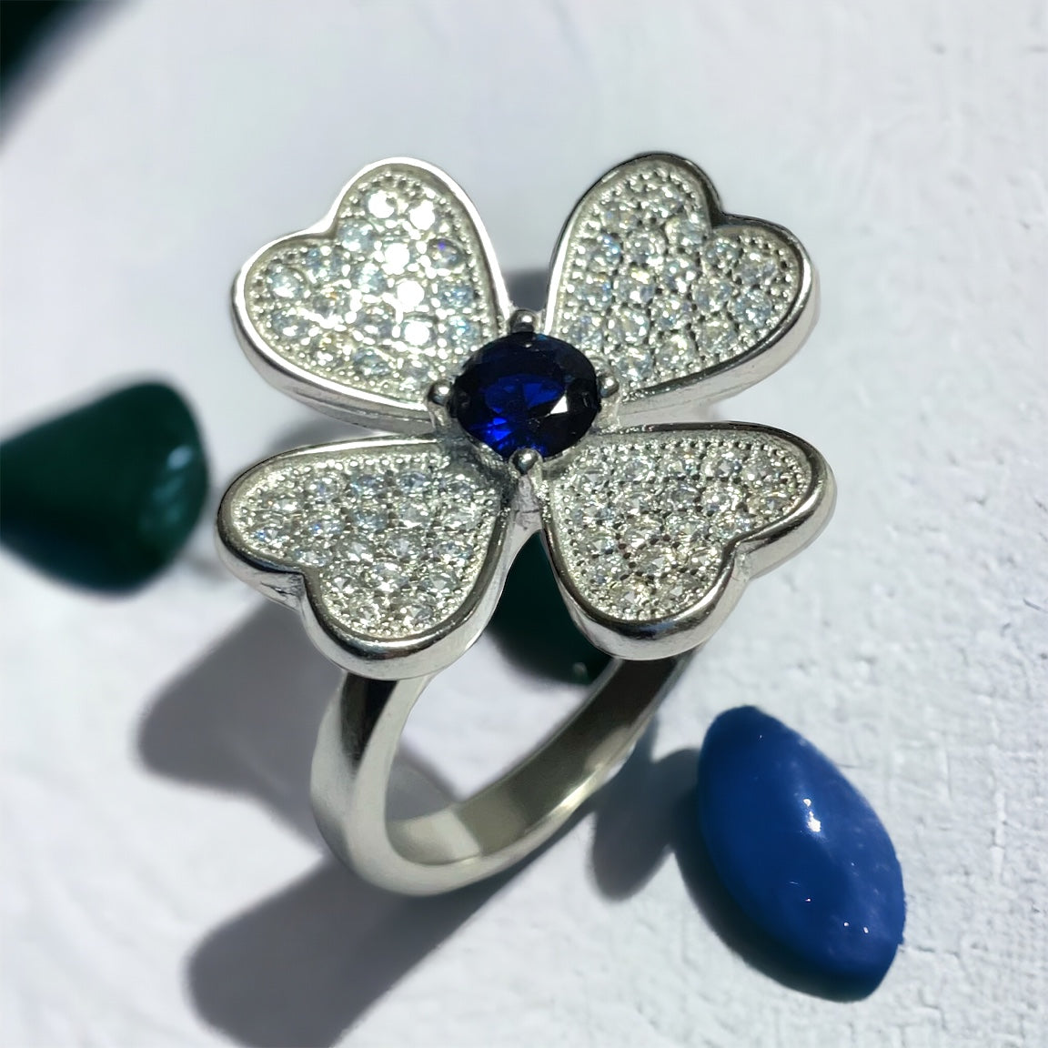 a ring with a blue stone in the middle of it