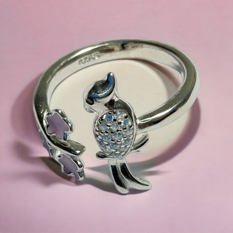 a silver ring with a bird on it
