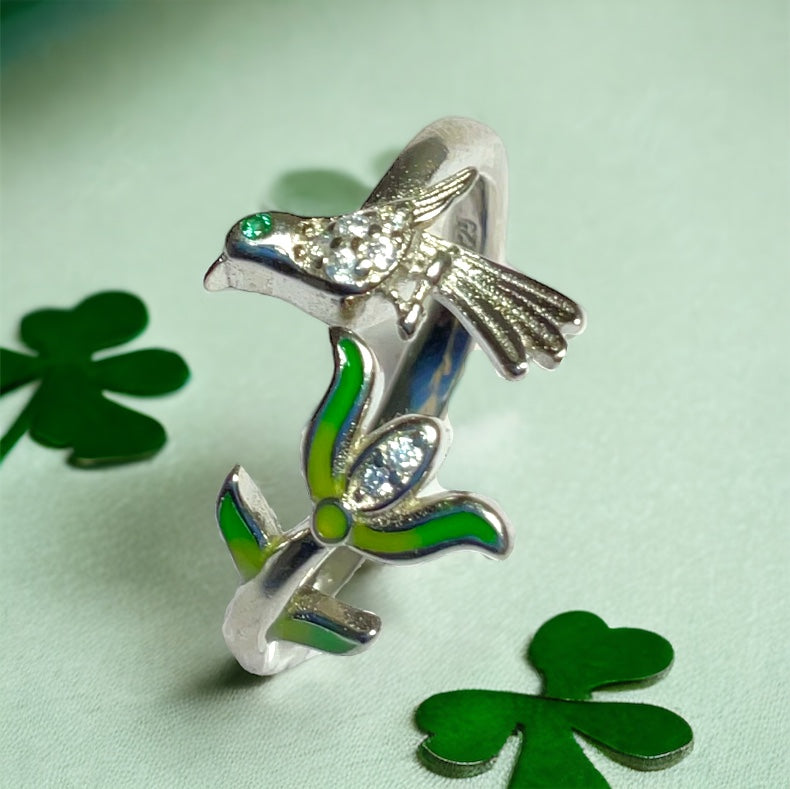 a close up of a ring with a bird on it