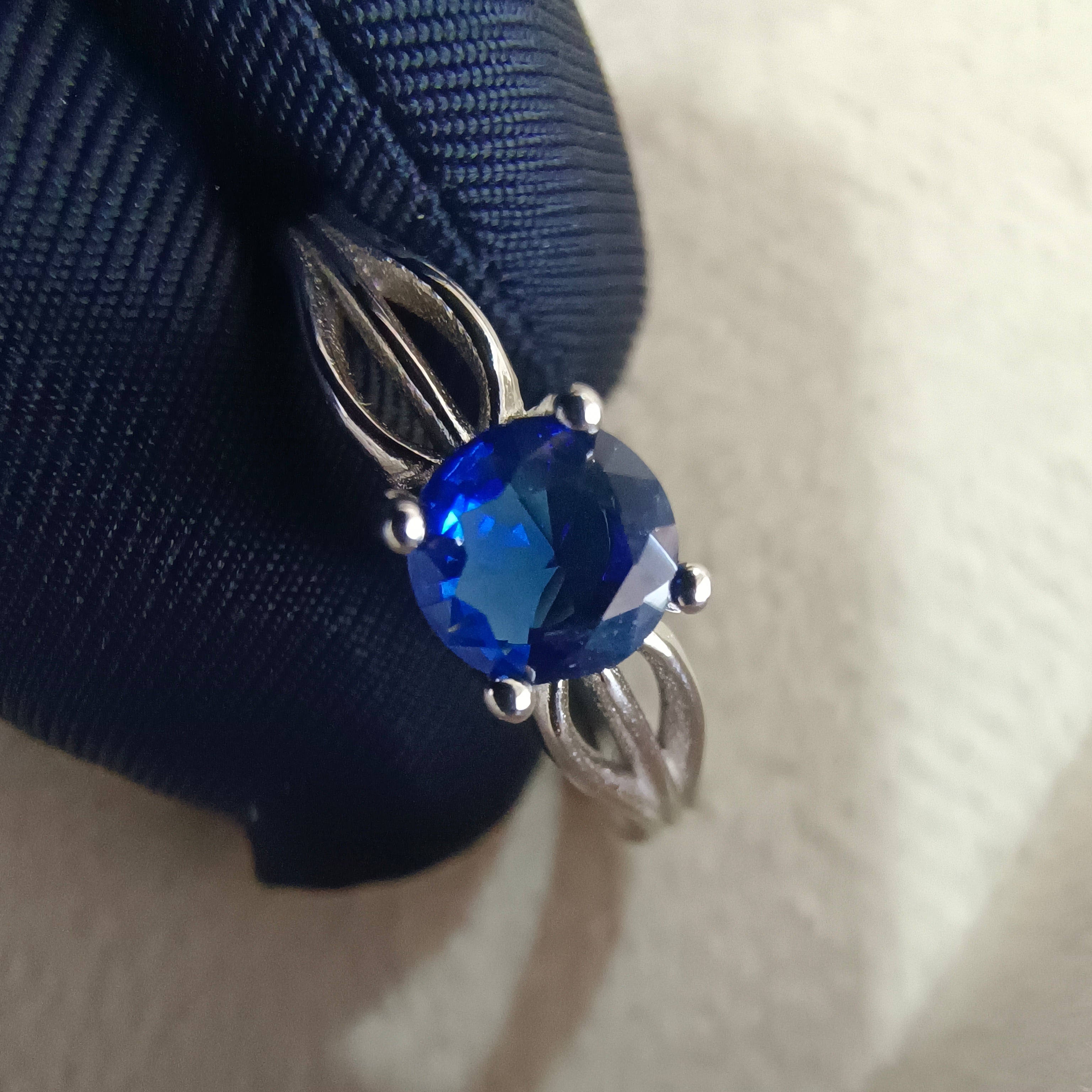a ring with a blue stone on top of it