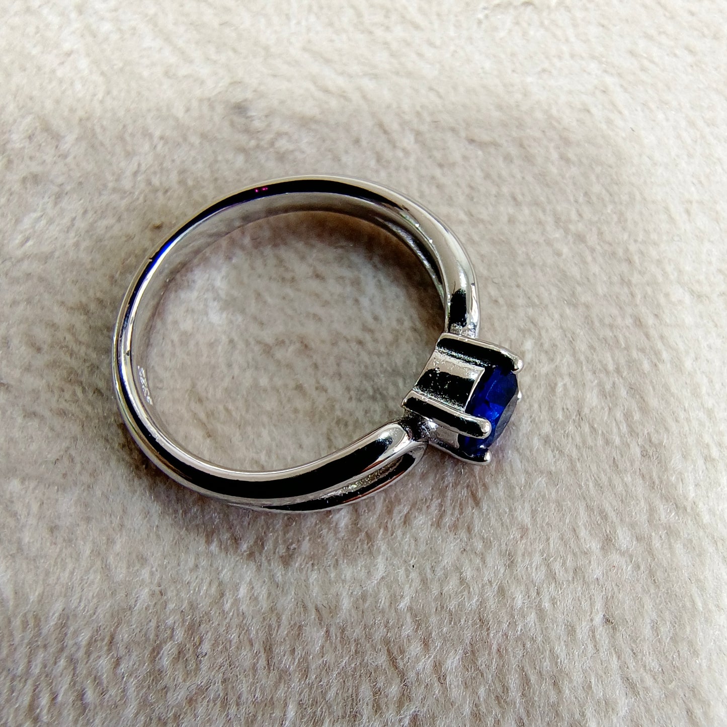 a close up of a ring on a white surface