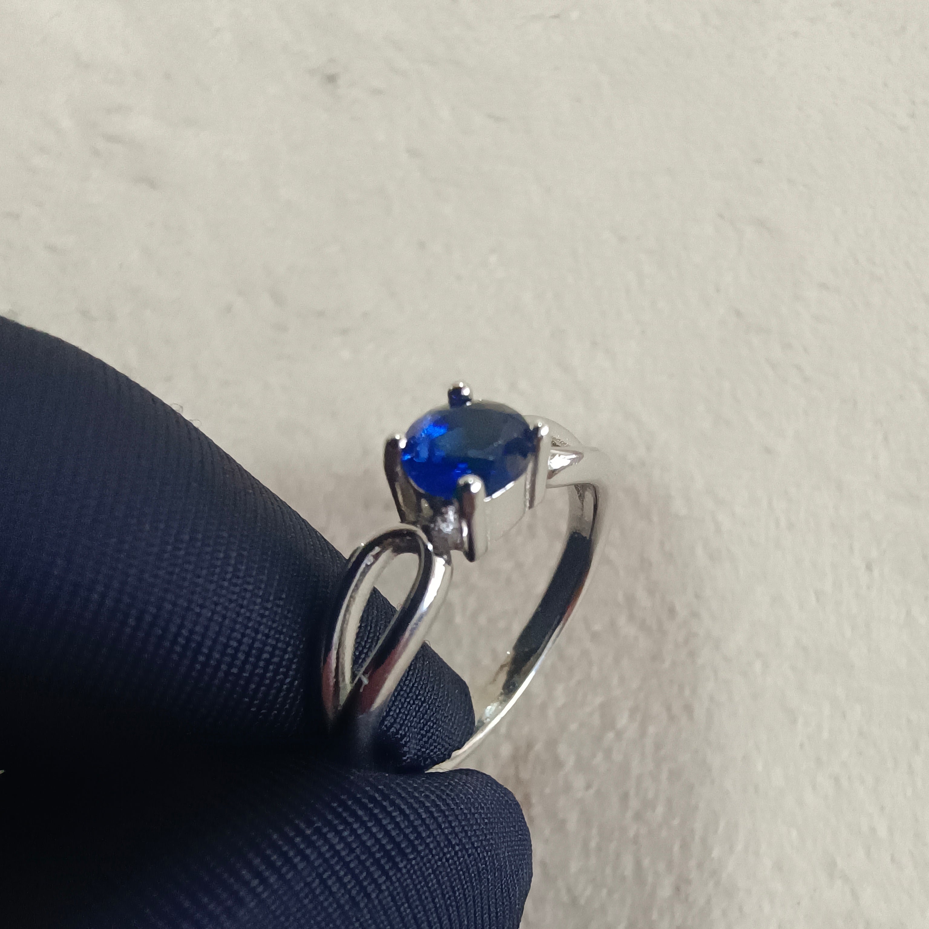 a blue ring sitting on top of a blue cloth