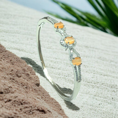 a close up of a bracelet on a beach